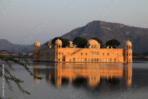 Jal Mahal reflected in the tranquil waters of Man Sagar Lake during golden hour in Jaipur, Rajasthan, India
