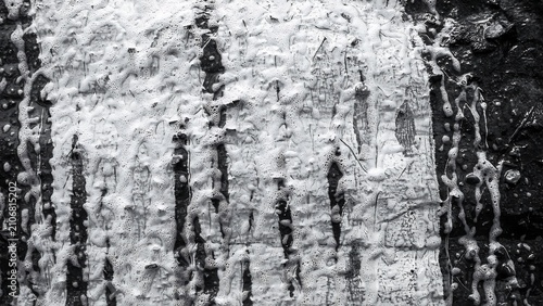 Abstract grungy black and white texture of striated stone wall surface