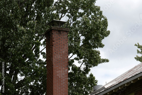 a damaged red brick chimney
