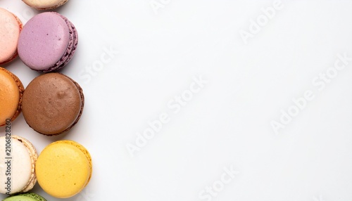 Colorful French Macarons Neatly Arranged in a Vertical Row on a Clean White Background with Generous Empty Copy Space for Creative Text