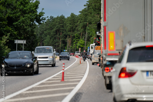 Принти на полотні Automobile congestion, freight transport trucks, and commuter cars driving slowl