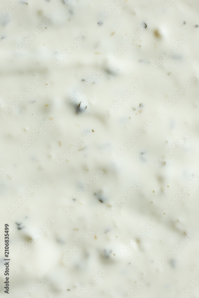 Obraz premium Close-up texture of creamy tartar sauce with herbs top view