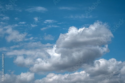 White cumulus clouds in a blue sky. Soft, cotton-like white clouds.