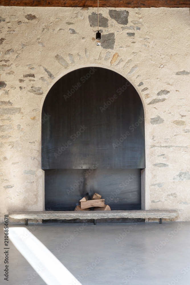 Obraz premium A close-up of an iron or steel fireplace, with pieces of wood inside.