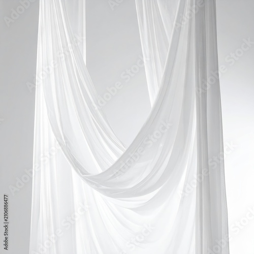Soft white fabric drapes gracefully with elegant folds and curves