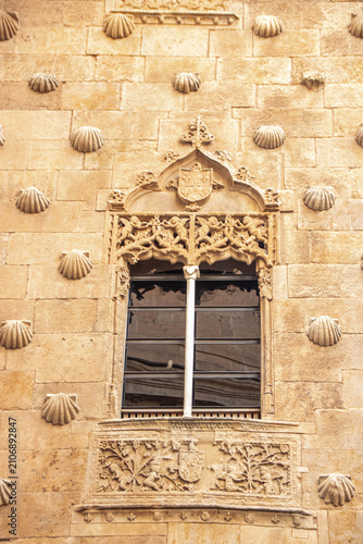 Ornate plateresque window detail of Casa de las Conchas in Salamanca