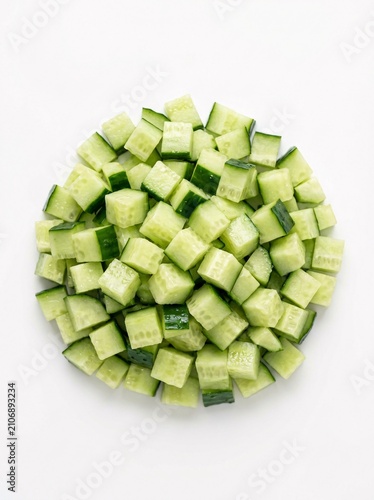 Fresh Diced Green Cucumber Cubes Piled on a Clean White Background for Food Preparation and Healthy Recipes