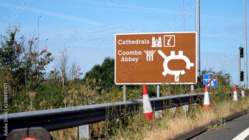 Photos Brown tourist road sign, roundabout direction sign pointing to Cathedrals and Co