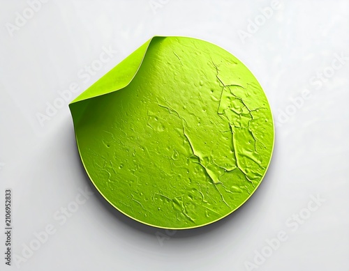 A peeled green sticker on a light gray background