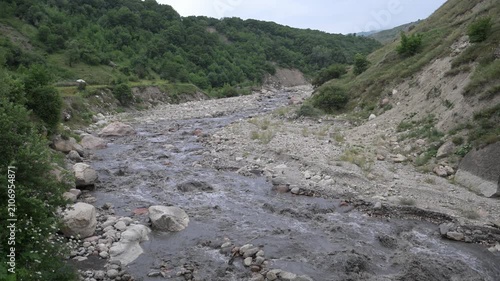 A mountain landscape with a beautiful mountain stream and a forest