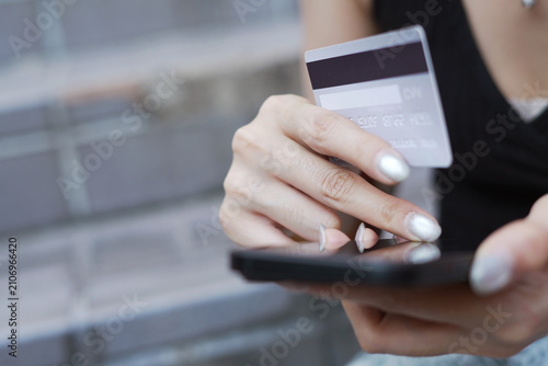 credit card.  Woman making an online purchase using a mobile phone. and digital shopping e-banking. concept  e-commerce make purchase or booking reservation. internet investment on mobile app.