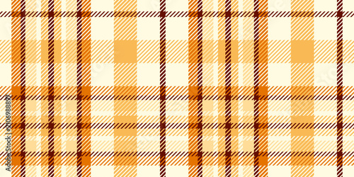 A seamless geometric tartan in a light honey-caramel colorway, classic tweed throw, and fabric texture make for cozy fall decor.
