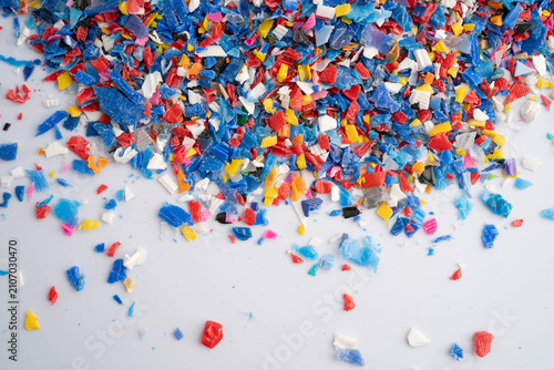 Fotografie Plastic colorful pieces recycling shredded for industrial use.