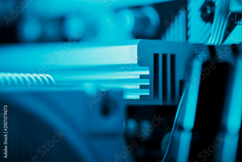 Macro close-up of PC heatsink fins illuminated by blue LED light