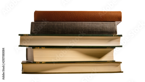 Obraz na płótnie Isolated vertical stack of vintage books with various textured covers and visibl