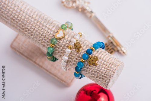 Canvas Print Handmade jewelry collection including gold earrings, beaded bracelets, and rings displayed on fabric stands for commercial product showcase
