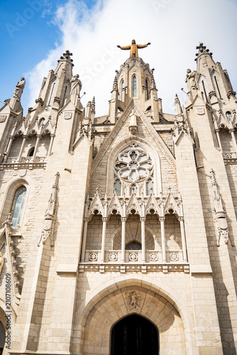 Фотография Ancient neo gothic cathedral church building facade with stone carved ornaments close up view