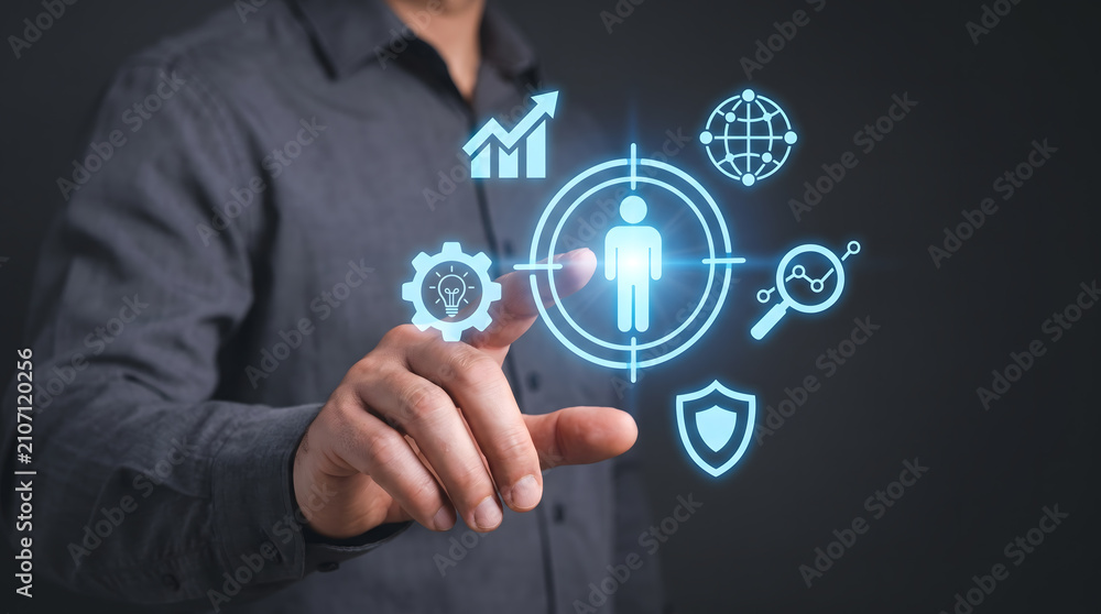 Obraz premium Target audience and customer relationship management: Businessman touching virtual human icon in target, Human resources and talent acquisition concept.