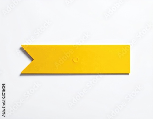A bright yellow arrow-shaped object with a small circular indentation