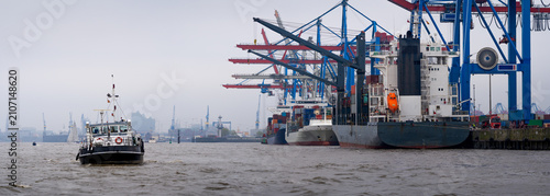 Tugboat on Elbe River by Container Terminal Cranes, Hamburg Germany