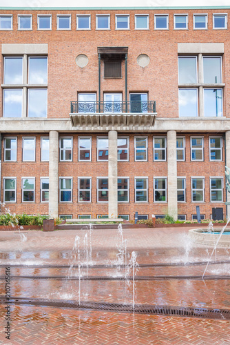 Water fountains in front of the historic town hall in Hengelo, Netherlands