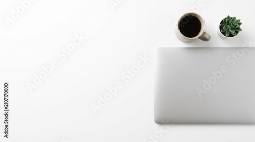 Minimalist flat lay of silver closed laptop, coffee cup, and succulent plant on clean white desk workspace with copy space