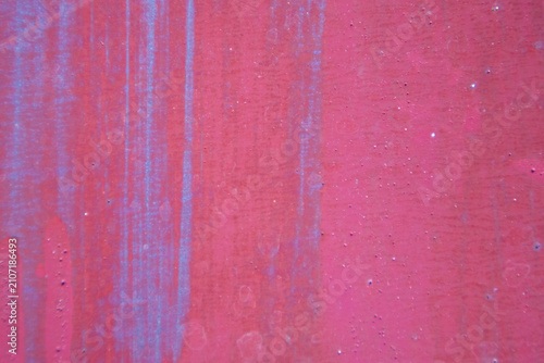 Close-up view of distressed pink surface featuring vertical color streaks and subtle stain effects. Modern artistic grunge texture background for banner cover and creative project.