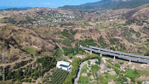 Aerial wide angle panoramic view of highway bridge to mountain tunnel