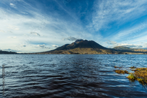Beautiful San Pablo Lake in Otavalo, Ecuador with the majestic Imbabura Volcano in the background under a blue sky. Rural landscape of the Ecuadorian Andes