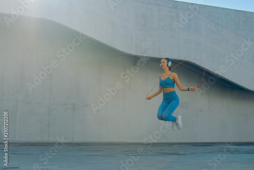 Bild auf Leinwand Skipper exercises outdoors in sporty attire, showcasing agility and fitness