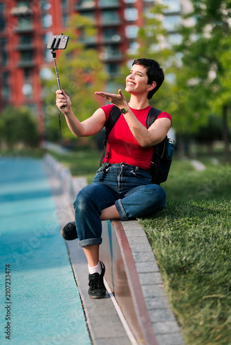 Woman creating social media content with smartphone outdoors