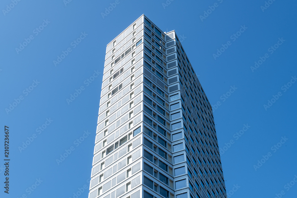 Obraz premium Modern skyscraper viewed from below against clear blue sky