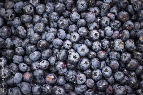 Tableau sur toile Dense cluster of dark blue blueberries, fresh fruit display, plump berry assortm