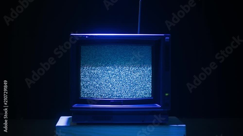 Retro TV, vintage television In a nostalgic setup, a retro TV displays grain on screen, scary halloween night device good for chroma key and green screen