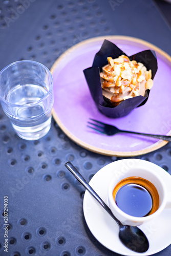 Espresso coffee served with caramel cupcake at an outdoor café