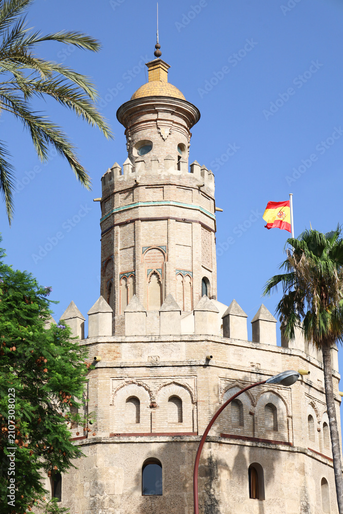 Fototapeta premium The Tower of Gold (Torre del Oro watchtower) next to The Guadalquivir river in Seville city
