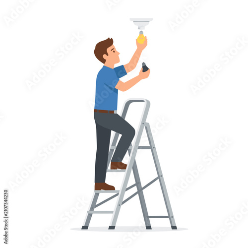 Man changing a light bulb while standing on a ladder