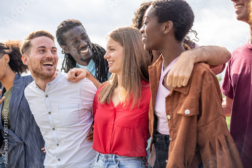 Cheerful Diverse Friends Group Embracing and Laughing Outdoors