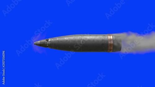 A metallic artillery shell projectile moves rapidly across a solid blue chroma key background. Perfect for visual effects artists needing compositable military ordinance and action shots.