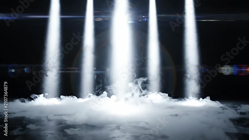 Vertical white spotlights through dense fog.