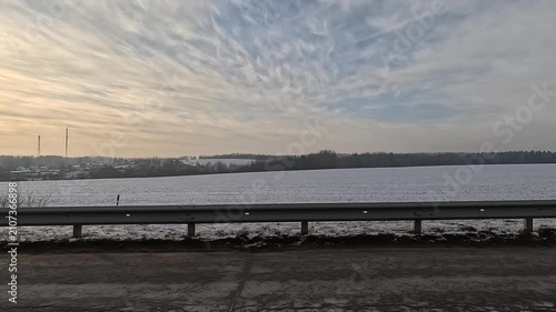 Along the road, on a white snowy winter day. roadside view, view from the car window	