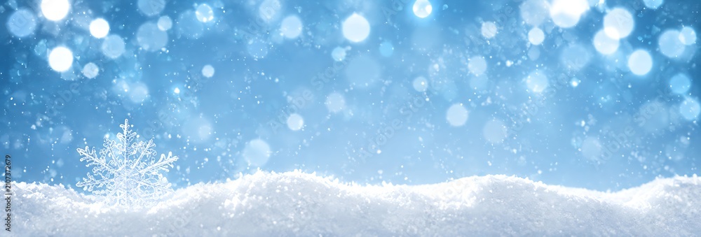 Fototapeta premium A magical winter scene with a delicate snowflake resting on a snowdrift, illuminated by shimmering bokeh lights. The blue tones evoke a sense of serene coldness and festive wonder