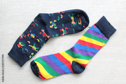Colorful, mismatched socks ready to be worn as a symbol of inclusion, diversity, and acceptance to promote respect for people with Down syndrome