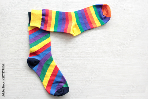 Colorful, mismatched socks ready to be worn as a symbol of inclusion, diversity, and acceptance to promote respect for people with Down syndrome