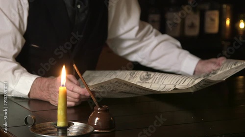 1880 man reading newspaper focus on inkwell