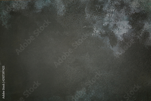 dark concrete texture with uneven light stains on the background