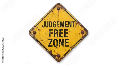 Weathered yellow diamond shaped metal sign displaying the text judgement free zone against white background
