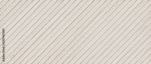 Bild auf Leinwand Light colored wooden planks arranged diagonally create a textured pattern on tra