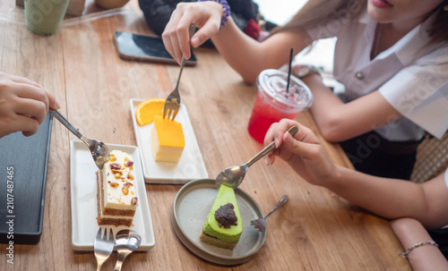 Group of Asian university student friends enjoying drinks and dessert in a modern cafe. Gen Z lifestyle, education, friendship, and leisure stock photo.