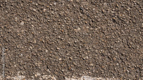 Rough asphalt aggregate texture with small stones close-up